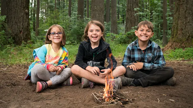 Apprentices learning fire skills in the forest